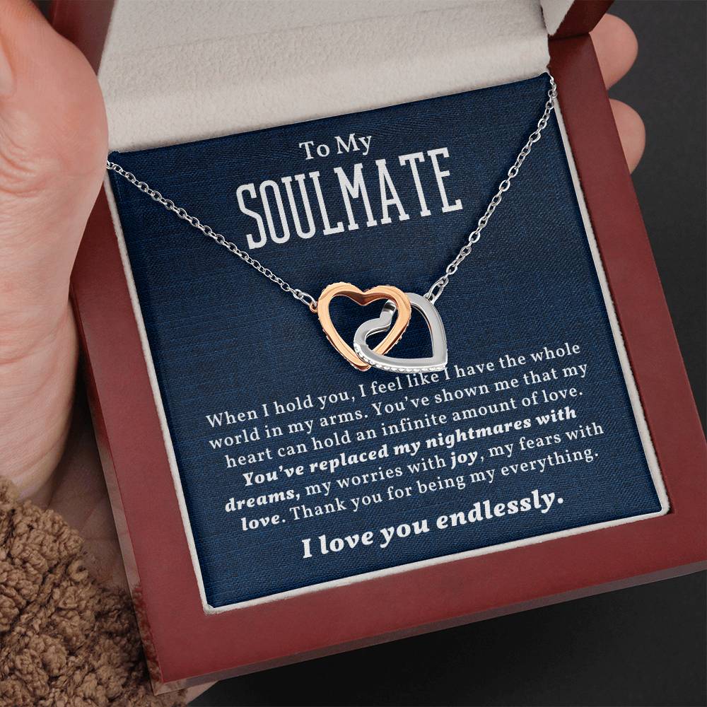 A heart-shaped necklace with two interlocking hearts, displayed in a gift box with a message card that reads 'To My Soulmate'.