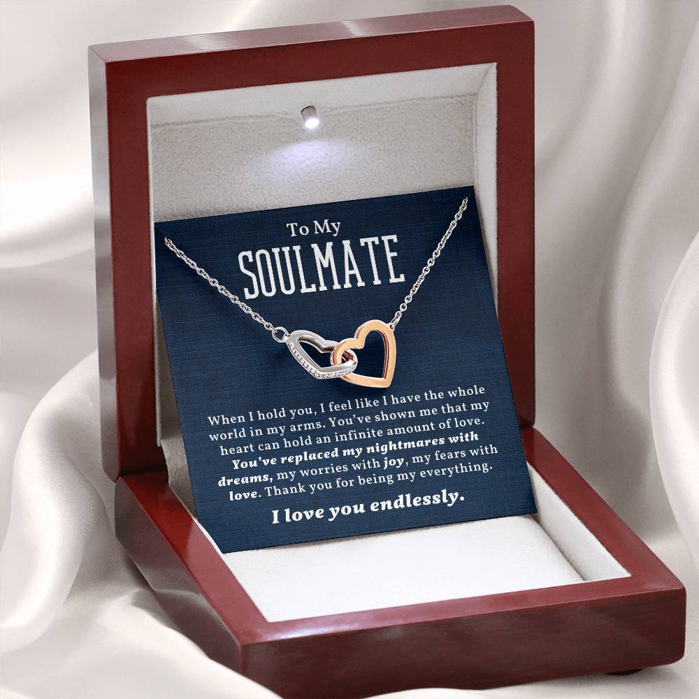 A heart-shaped necklace with two interlocking hearts, displayed in a gift box with a message card that reads 'To My Soulmate'.