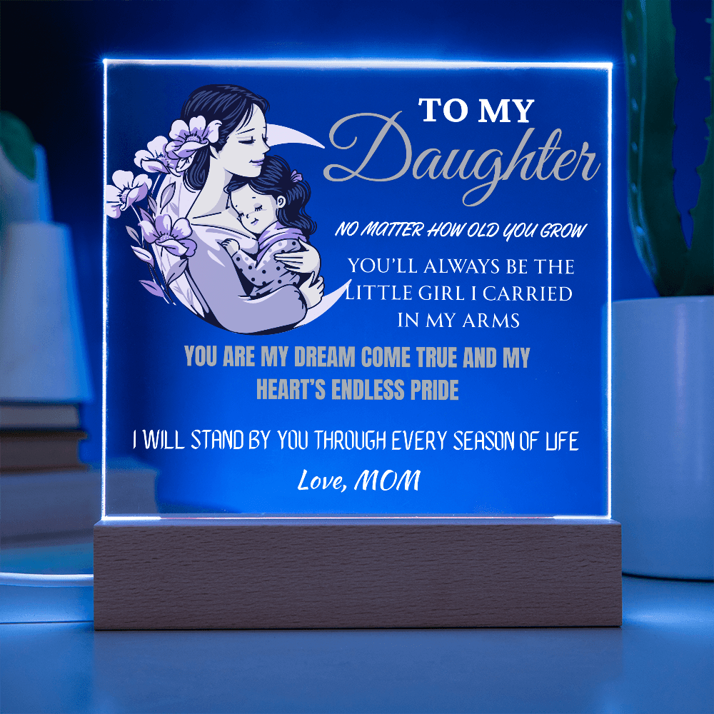 Decorative lamp with a mother and daughter illustration and engraved text on a blue background.