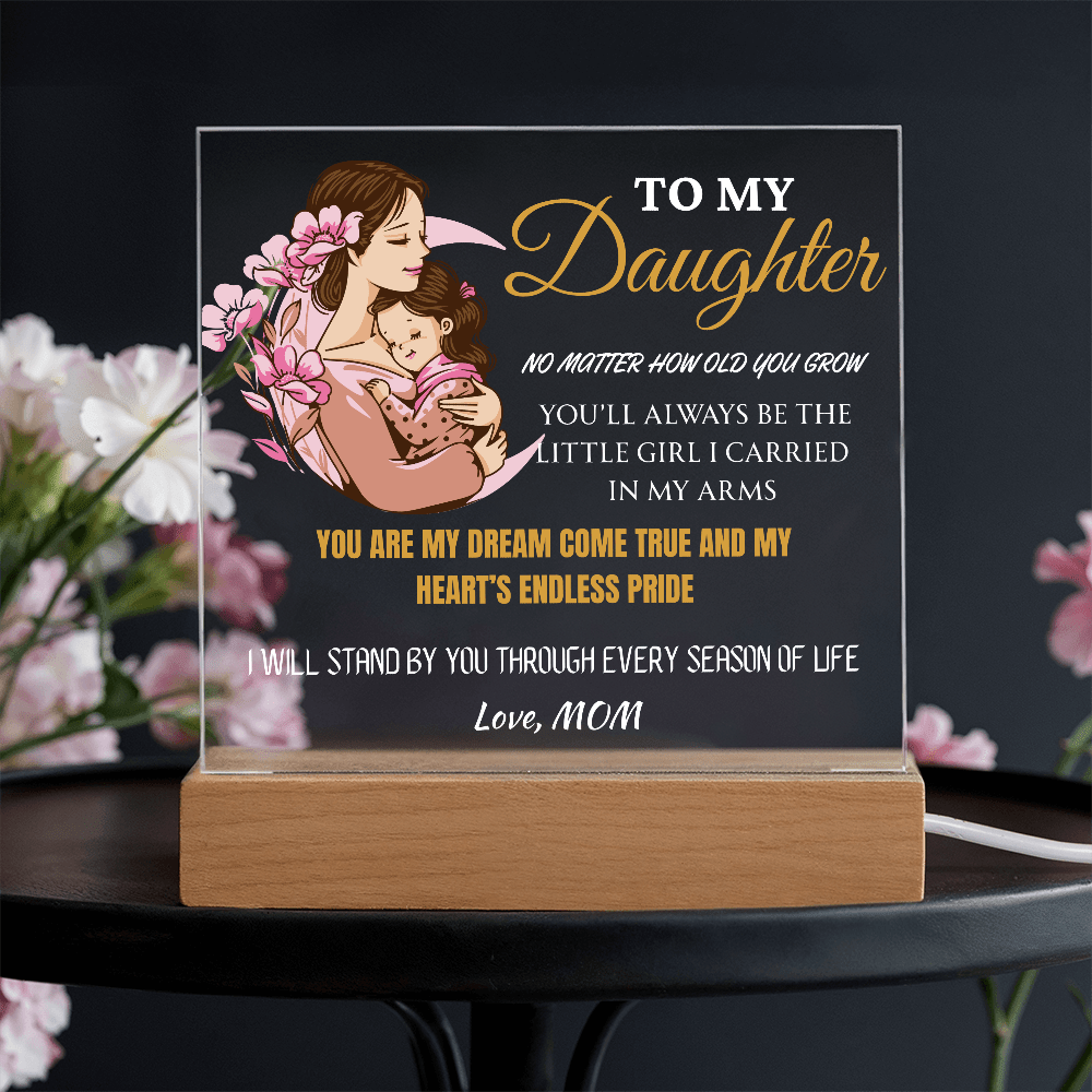 Decorative plaque with a mother and daughter illustration and sentimental text on a dark background.