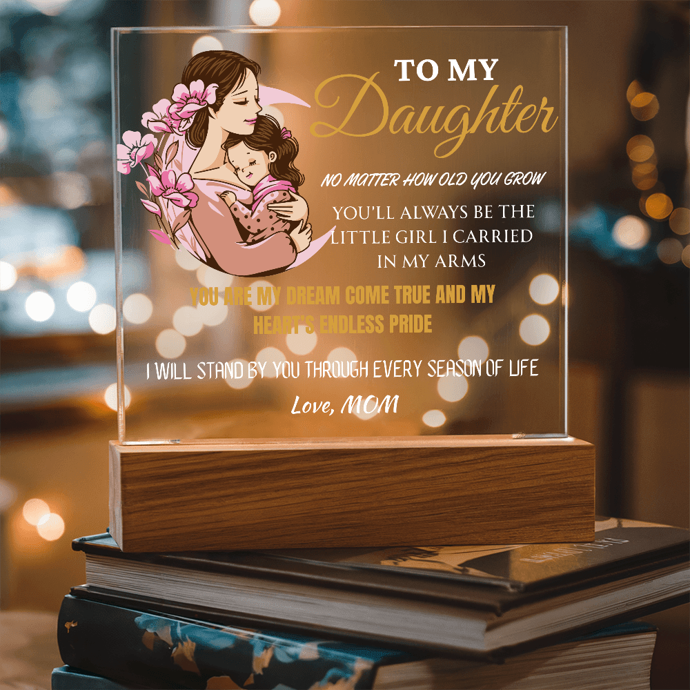 Acrylic plaque with a mother and daughter illustration and sentimental text on a blurred background.