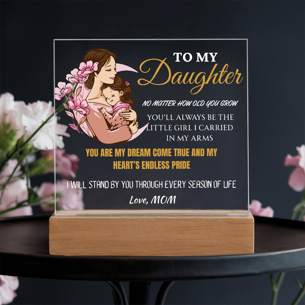 Decorative plaque with a mother and daughter illustration and sentimental text on a dark background.