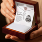 Graduation-themed necklace in a wooden box with a card inside.
