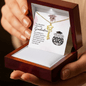 Graduation-themed necklace in a wooden box with a card inside.