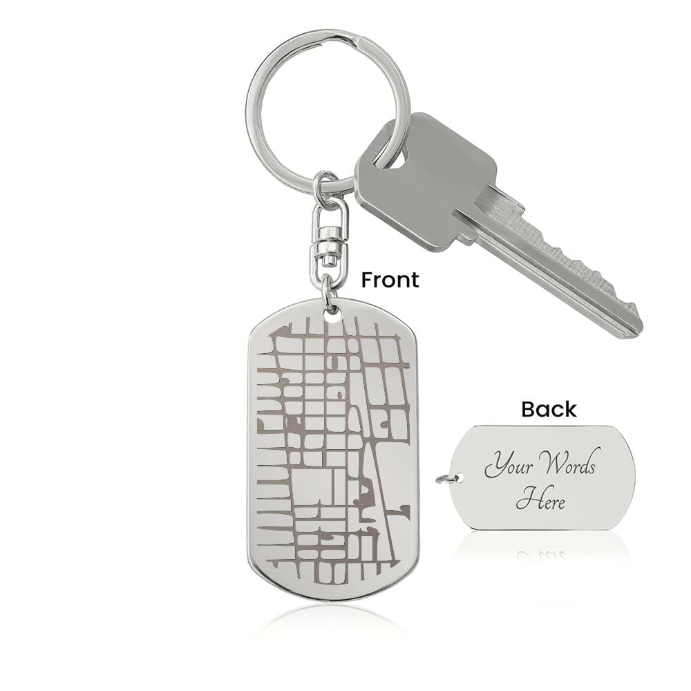 Silver keychain with map design on a white background